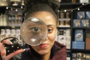 Image of a woman looking through a magnifying glass