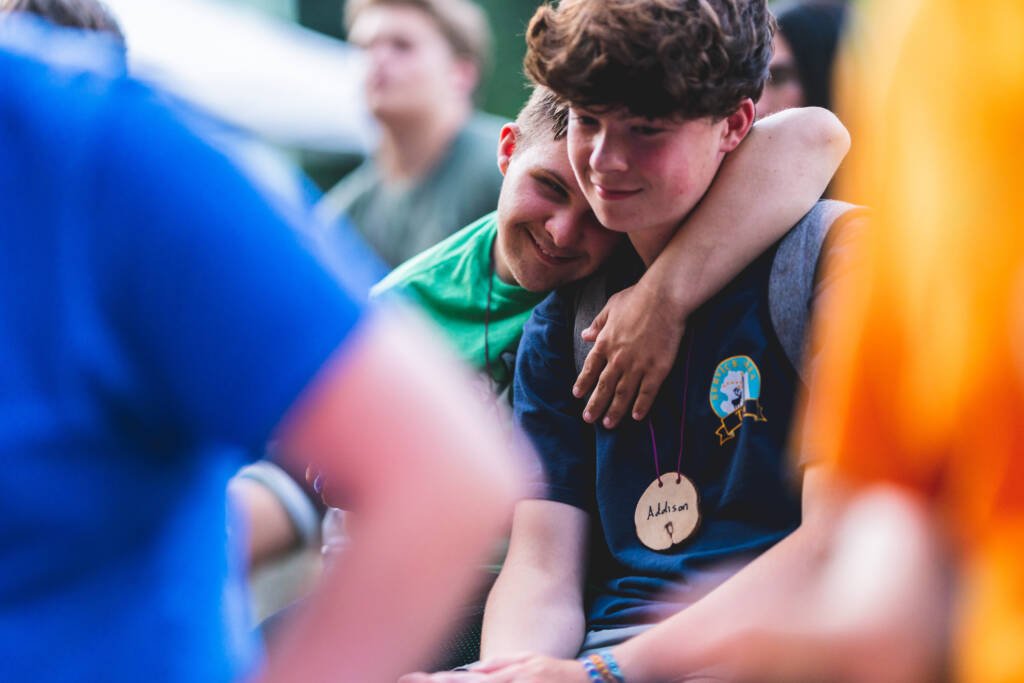 Photo: Camper hugging counselor.