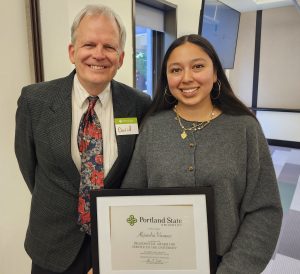 David Peterson Del Mar standing next to Alejandra Vazquez holding a framed certificate