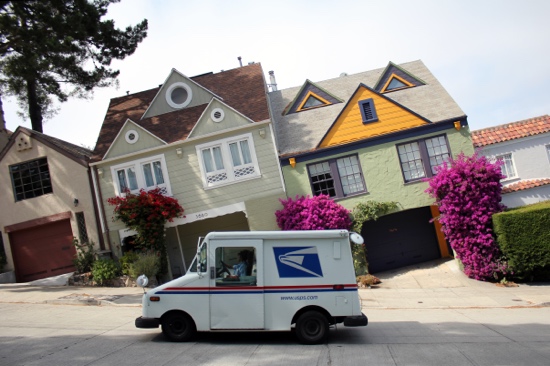 Photograph: A mail truck parked on a hill, with the photo frame oriented parallel to the crooked ground