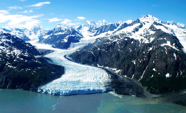 An aerial view of Margerie Glacier. The glacier begins high in the mountains and meanders down the valleys like a river of ice.