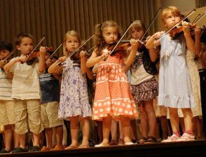 A group of children playing violins