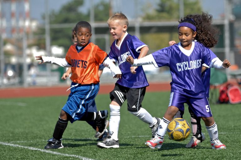'a group of kids playing football'
