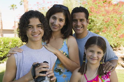 Image shows a family: teenaged boy, younger girl, and two adults