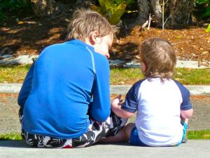 Two siblings sitting together talking