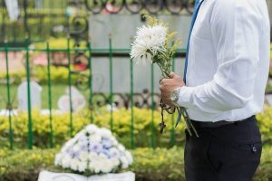 A person at a funeral holding flowers