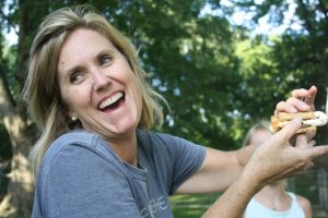 Woman smiling while holding a s'more